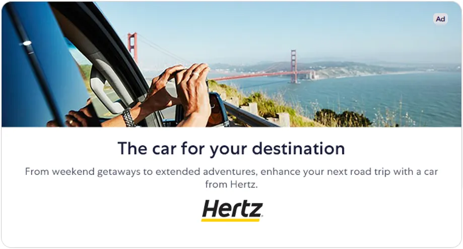 Hertz interstitial on Expedia: a car on a coastal road with the headline The car for your destination.